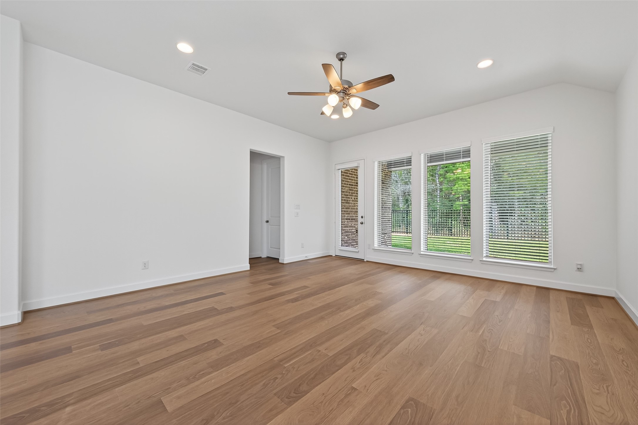 122 Sierra Strm Court Conroe, TX 77304 - Photo 19 of 40 a view of an empty room with wooden floor and a window