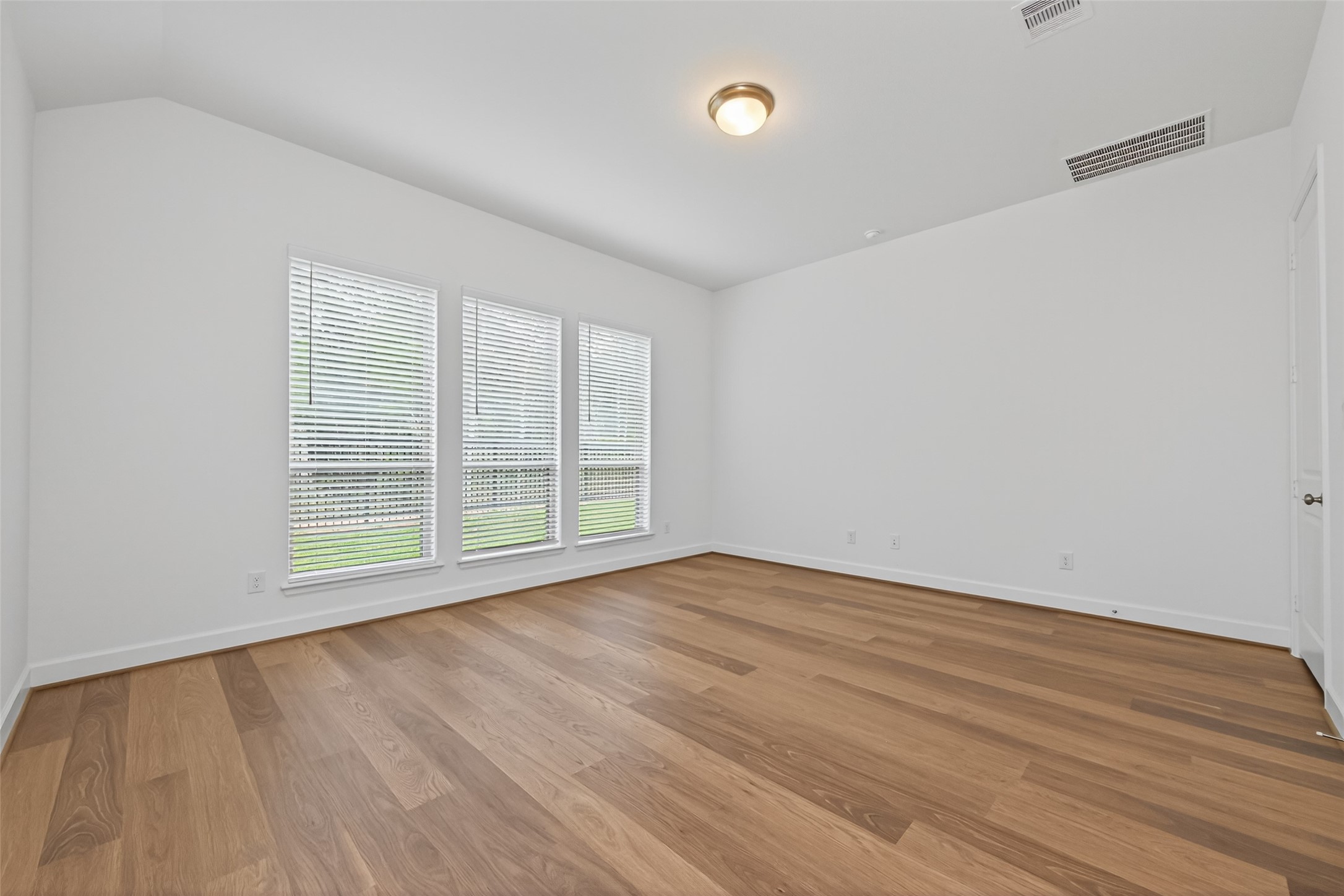 122 Sierra Strm Court Conroe, TX 77304 - Photo 26 of 40 wooden floor in an empty room with a window