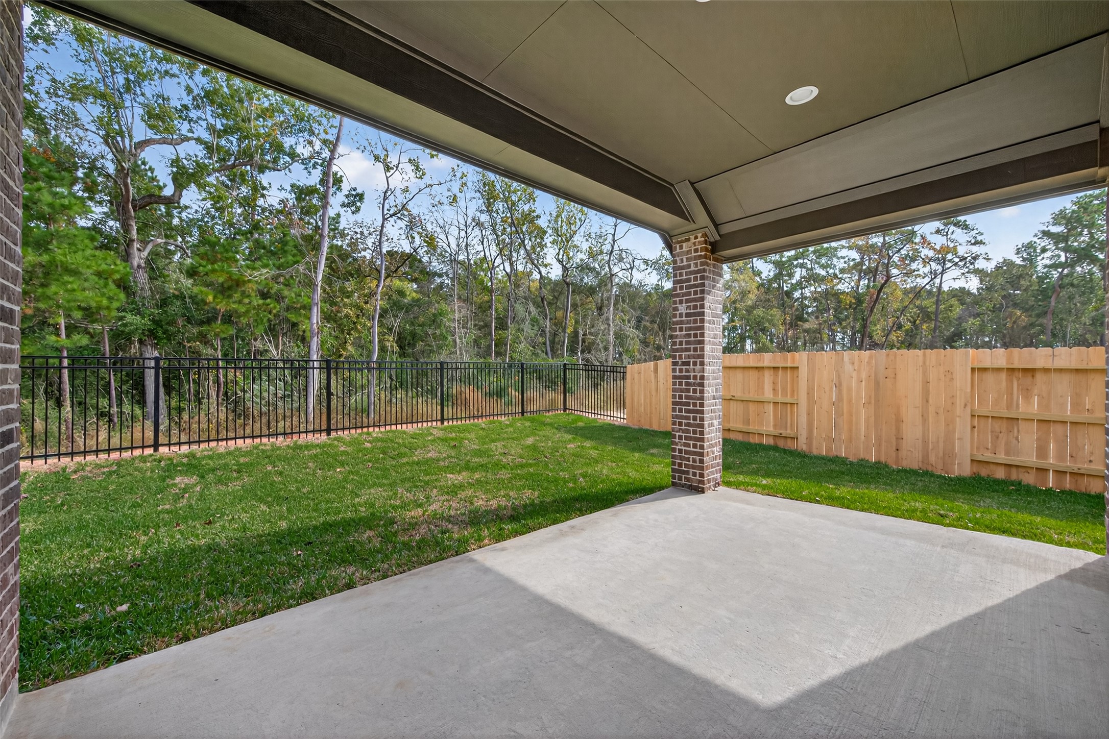 122 Sierra Strm Court Conroe, TX 77304 - Photo 36 of 40 a view of a yard with porch and wooden fence