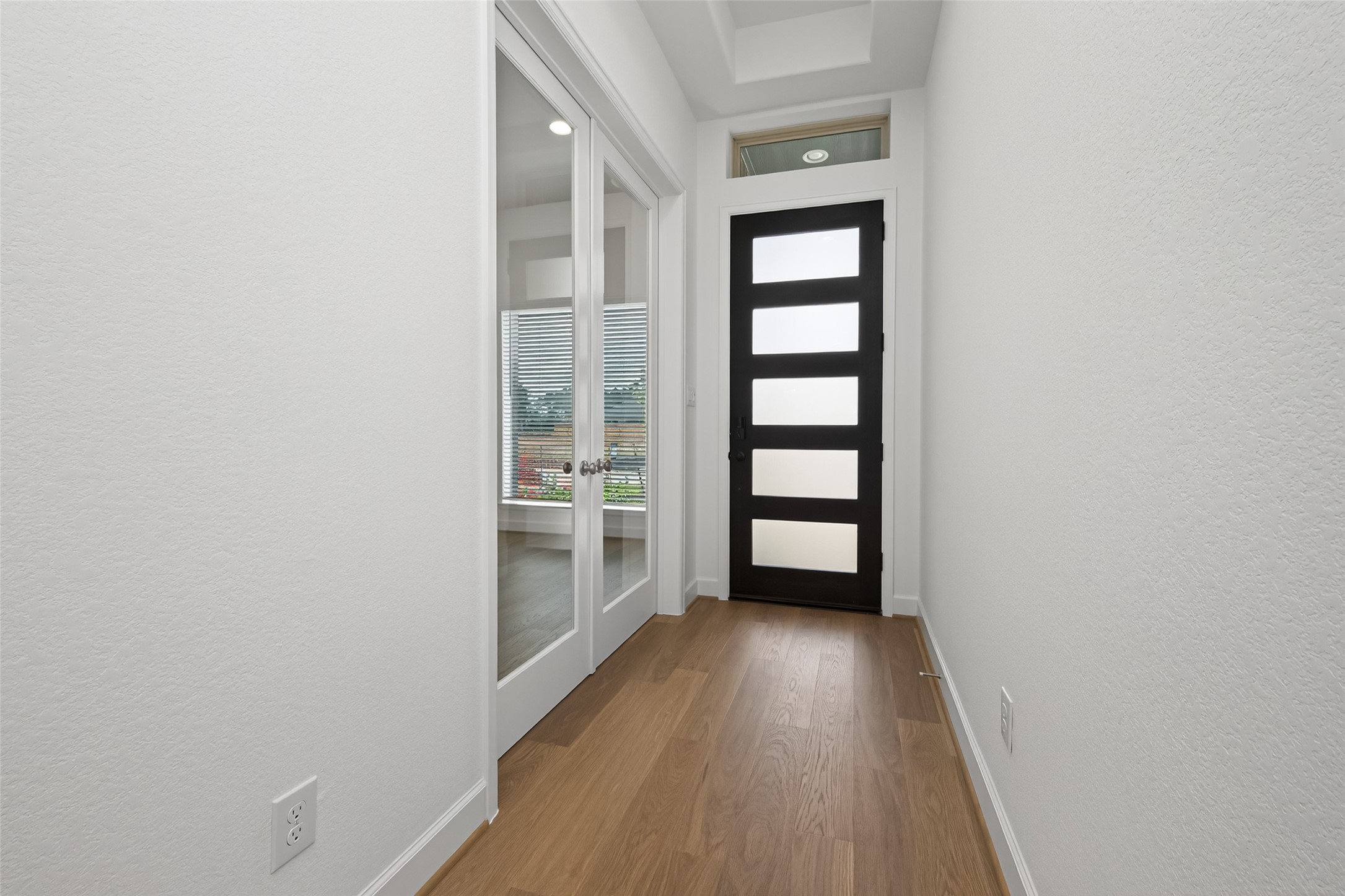 122 Sierra Strm Court Conroe, TX 77304 - Photo 4 of 40 an empty room with wooden floor and a window