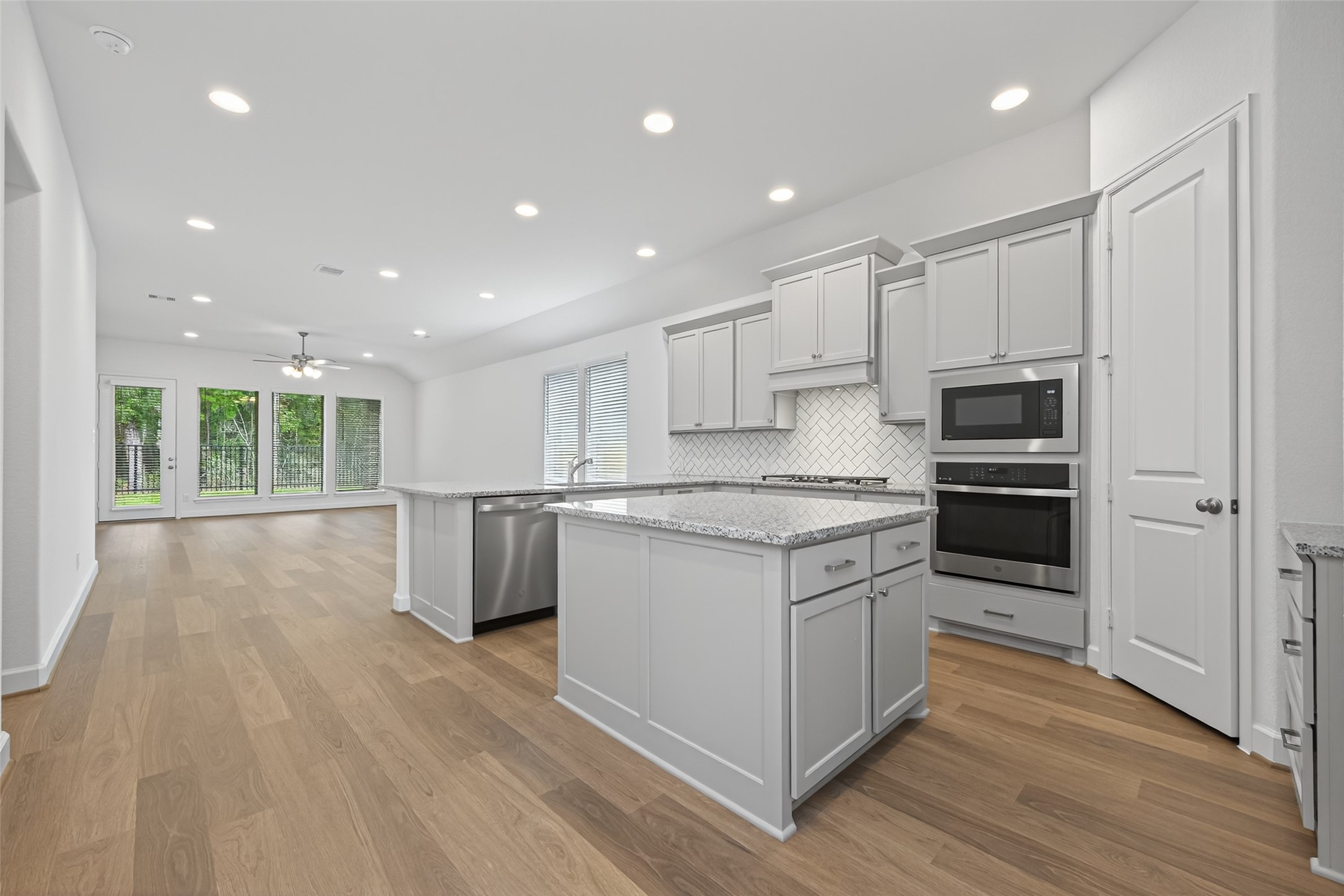 122 Sierra Strm Court Conroe, TX 77304 - Photo 8 of 40 a kitchen with stainless steel appliances granite countertop a stove a sink and a refrigerator
