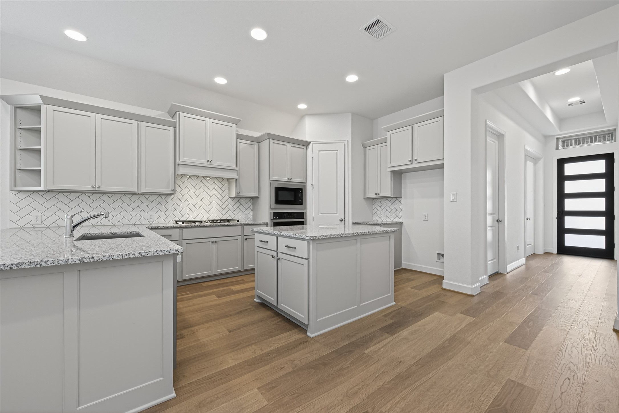 122 Sierra Strm Court Conroe, TX 77304 - Photo 9 of 40 a kitchen with white cabinets and sink