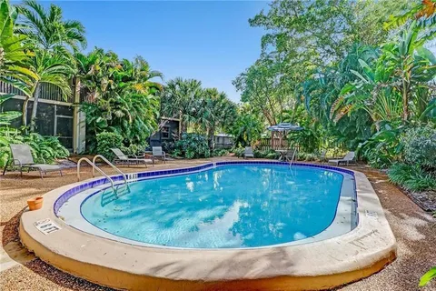 a view of a swimming pool with a yard