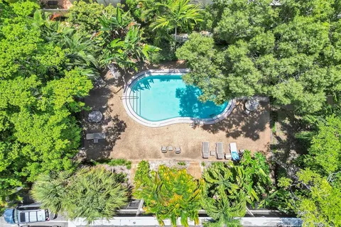 an aerial view of a residential house with a yard