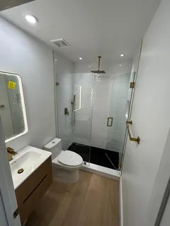 a bathroom with a sink toilet and shower