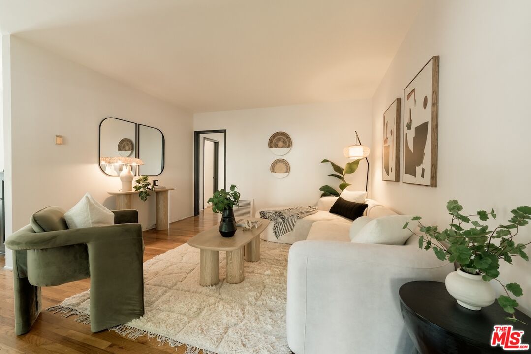 a living room with furniture and a mirror