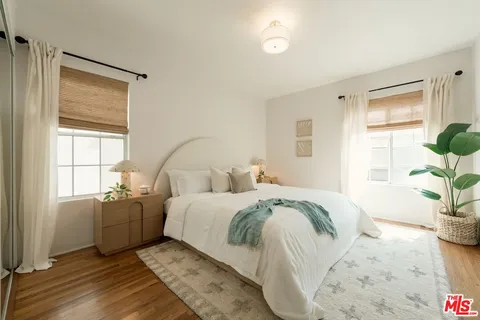 a bed room with a bed and a potted plant