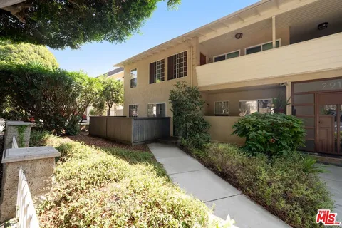 a view of house with backyard and garden