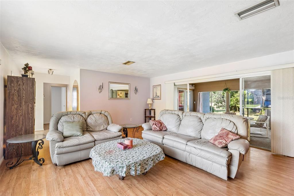 2059 Waterfall Drive Spring Hill, FL 34608 - Photo 5 of 26 a living room with furniture and wooden floor