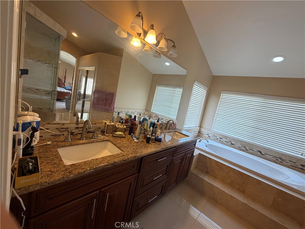 19823 Mariposa Pines Way Porter Ranch, CA 91326 - Photo 32 of 50 a bathroom with a sink double vanity and a mirror
