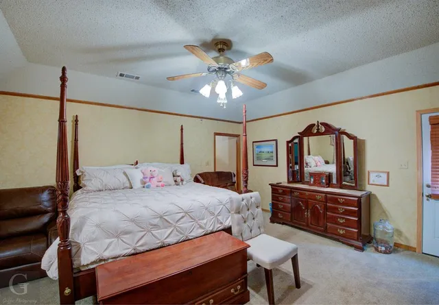 a living room with stainless steel appliances furniture and a refrigerator