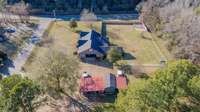 an aerial view of a house with a yard