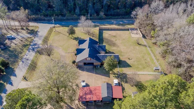 an aerial view of residential house with outdoor space and parking