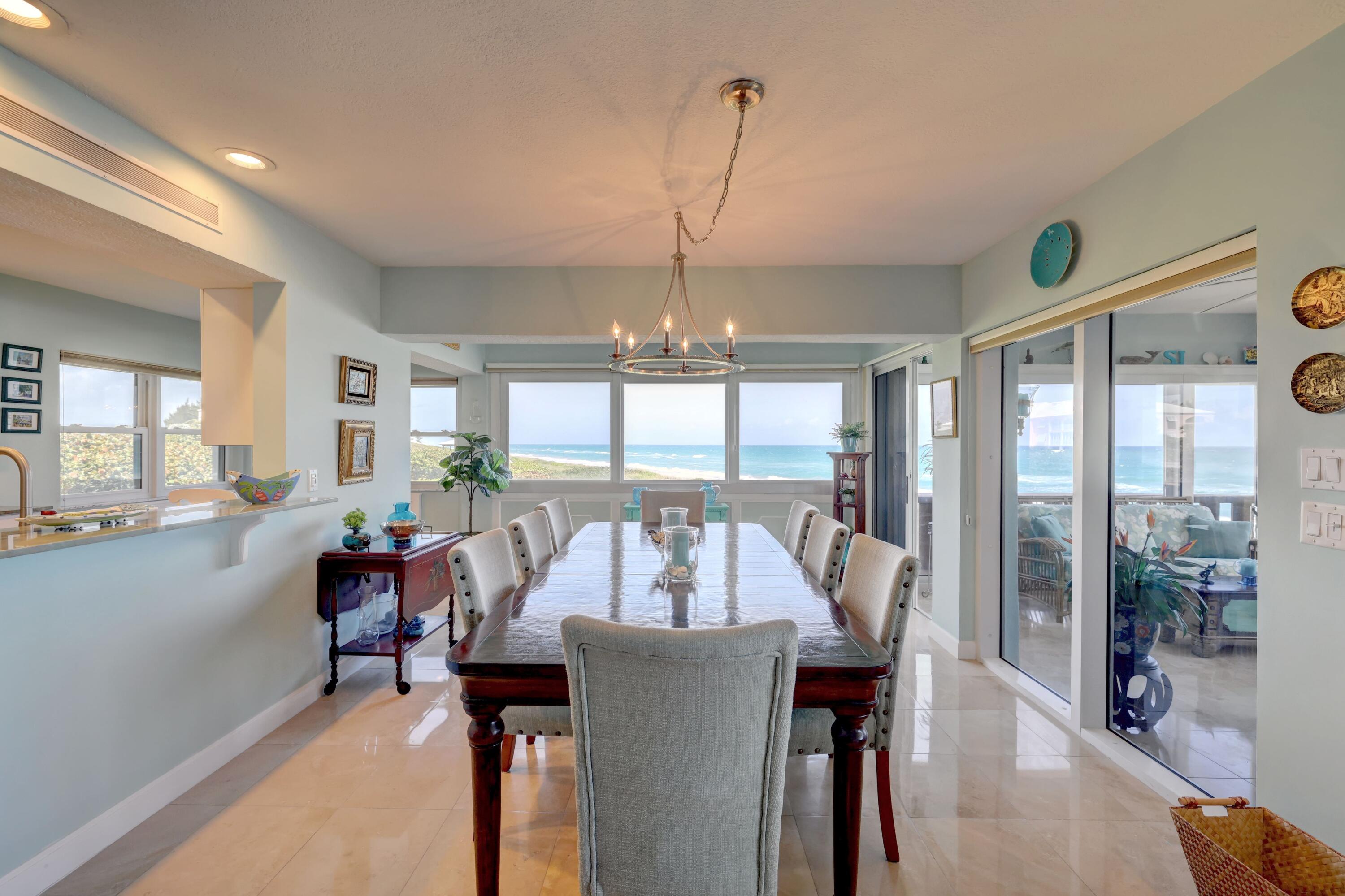 1555 Northeast Ocean Boulevard, Unit 205 Stuart, FL 34996 - Photo 15 of 57 a living room with furniture and a chandelier
