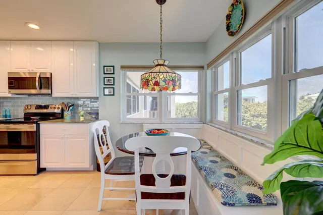 a kitchen with stainless steel appliances granite countertop a refrigerator oven a sink dishwasher and white cabinets with wooden floor