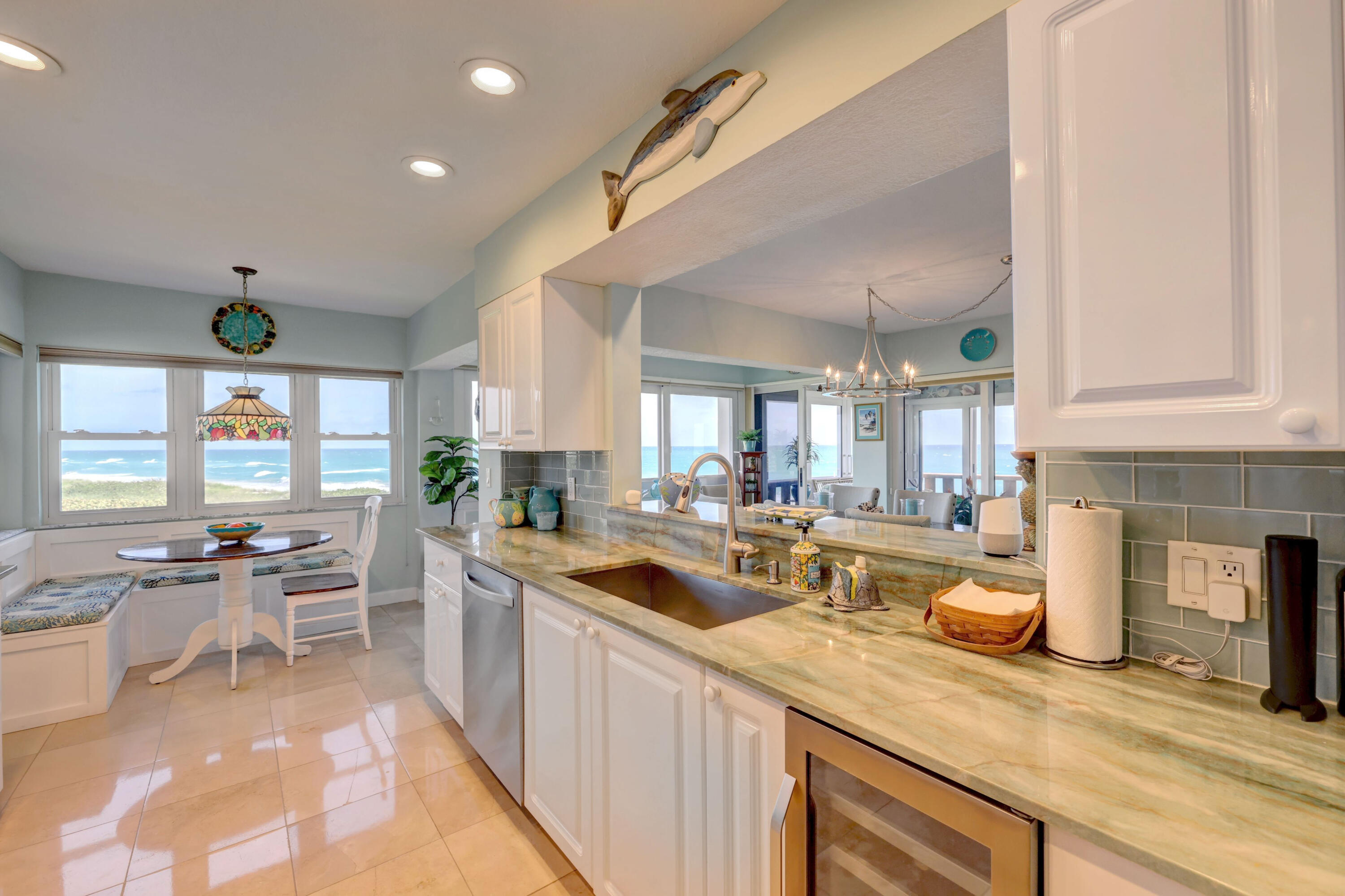1555 Northeast Ocean Boulevard, Unit 205 Stuart, FL 34996 - Photo 20 of 57 a kitchen with lots of counter top space and living room