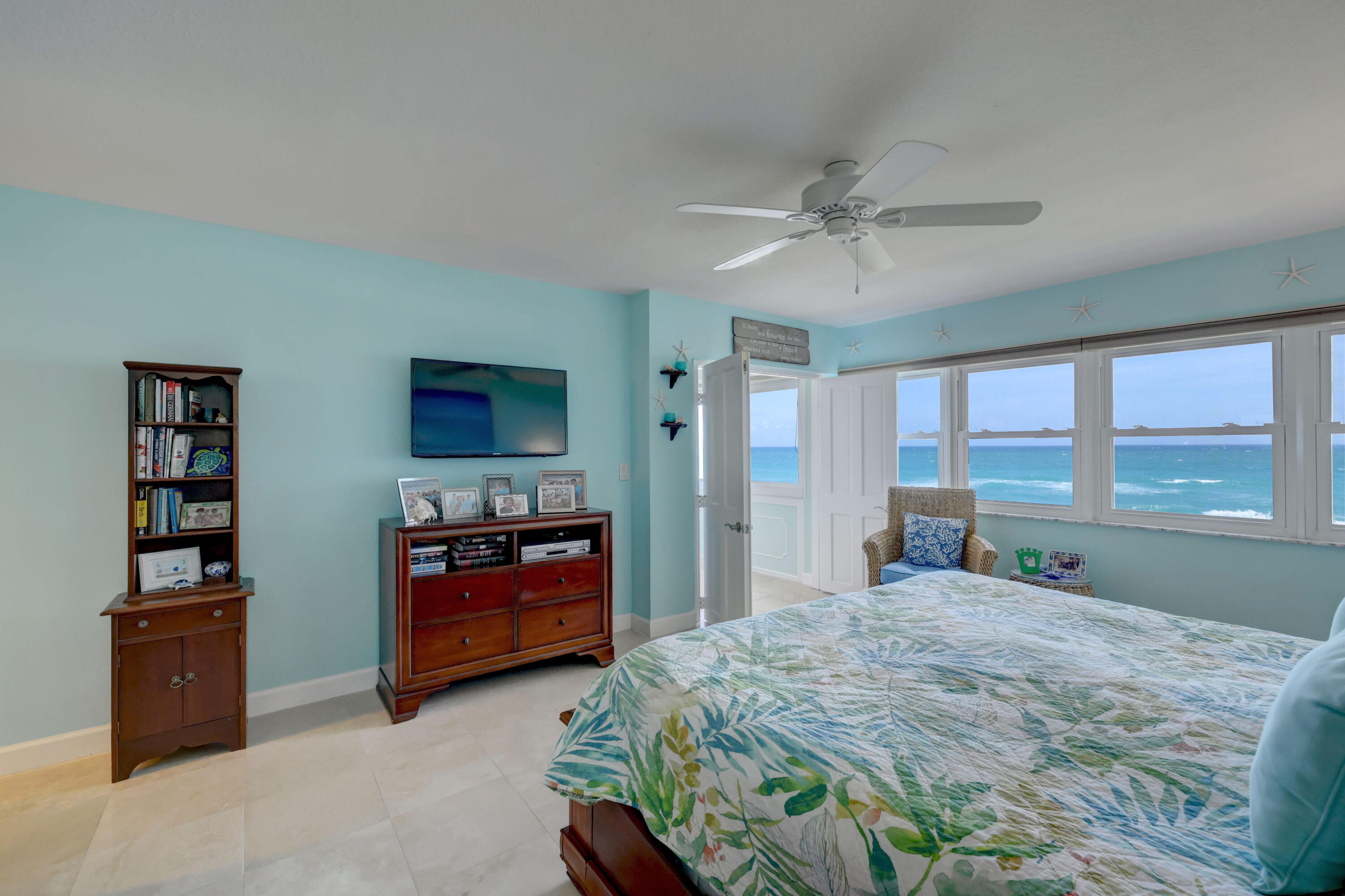 1555 Northeast Ocean Boulevard, Unit 205 Stuart, FL 34996 - Photo 23 of 57 a bedroom with a bed and a large window