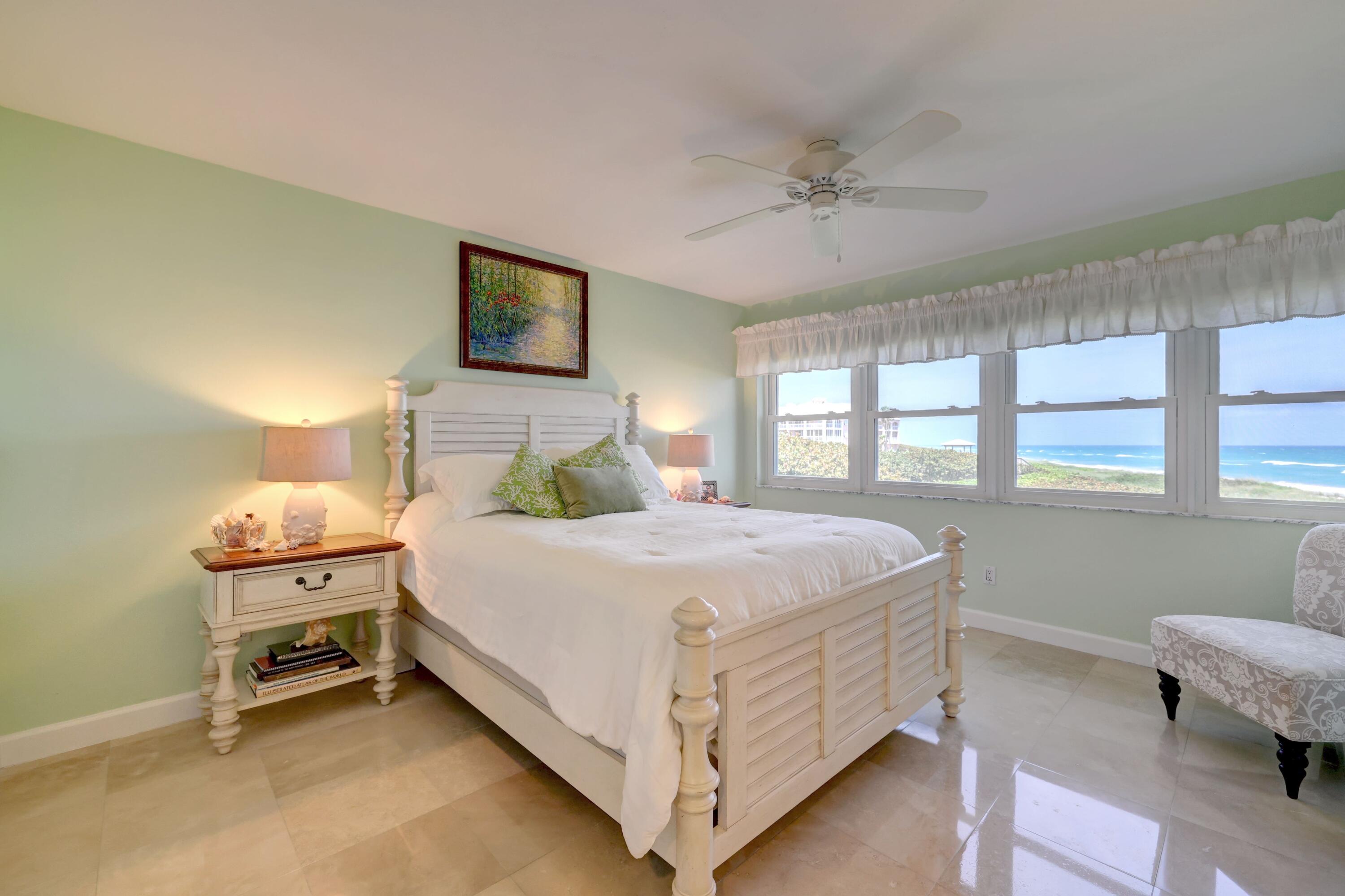 1555 Northeast Ocean Boulevard, Unit 205 Stuart, FL 34996 - Photo 28 of 57 a bedroom with a bed and a window