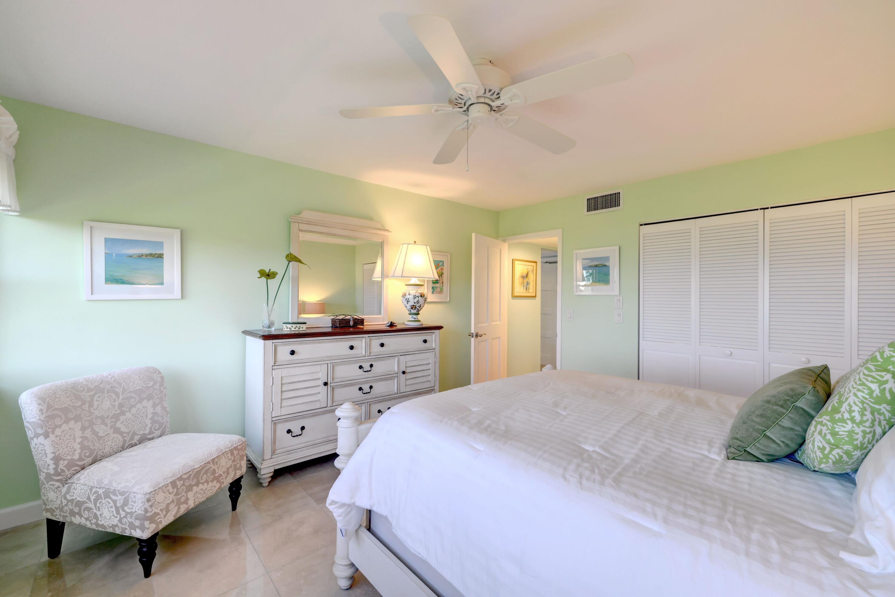 1555 Northeast Ocean Boulevard, Unit 205 Stuart, FL 34996 - Photo 30 of 57 a bedroom with a bed a couch and dresser