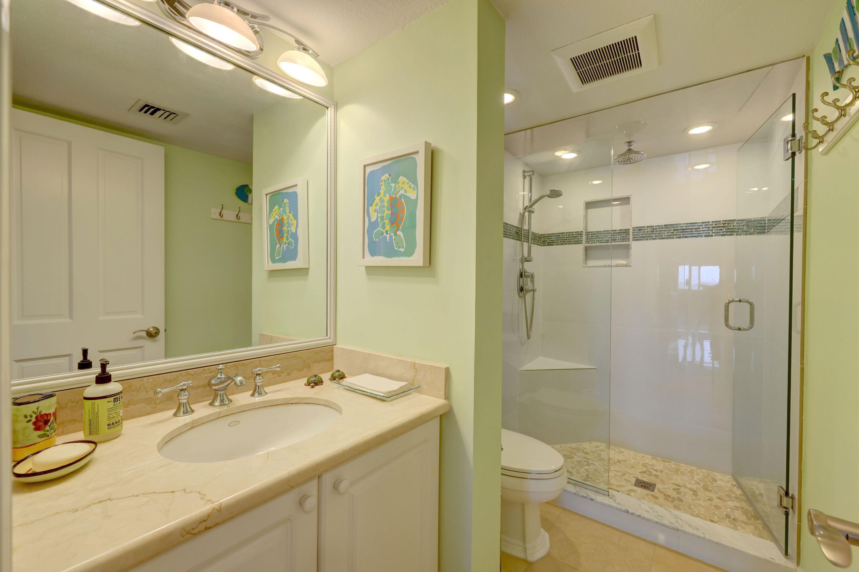 1555 Northeast Ocean Boulevard, Unit 205 Stuart, FL 34996 - Photo 31 of 57 a bathroom with a granite countertop sink a toilet a shower and a mirror