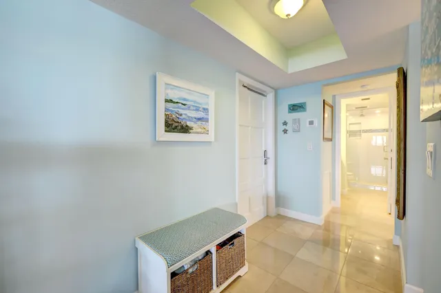 a living room with furniture and floor to ceiling windows