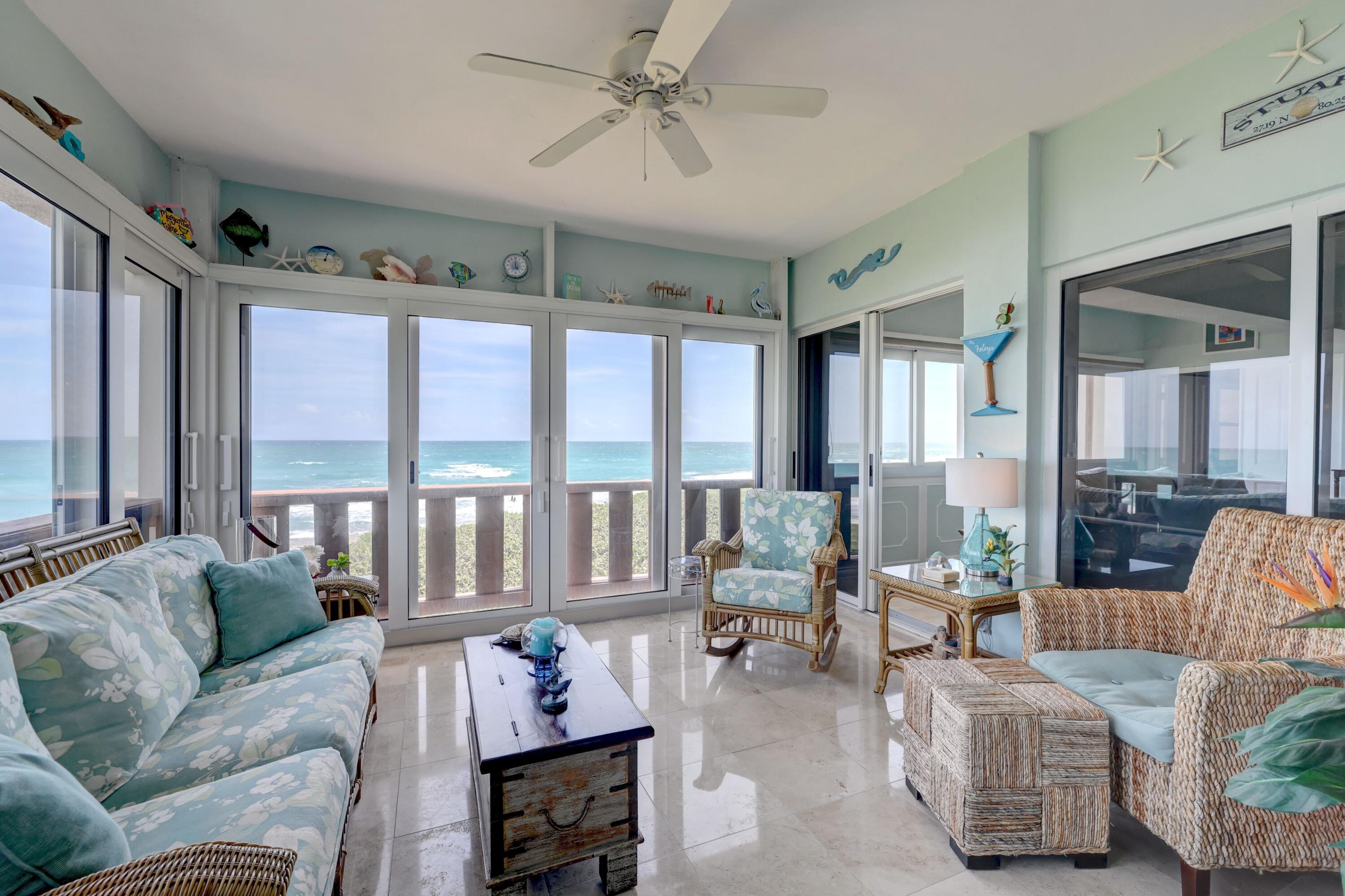 1555 Northeast Ocean Boulevard, Unit 205 Stuart, FL 34996 - Photo 33 of 57 a living room with furniture and floor to ceiling windows