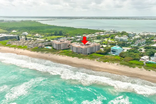a view of a house with a yard balcony and furniture