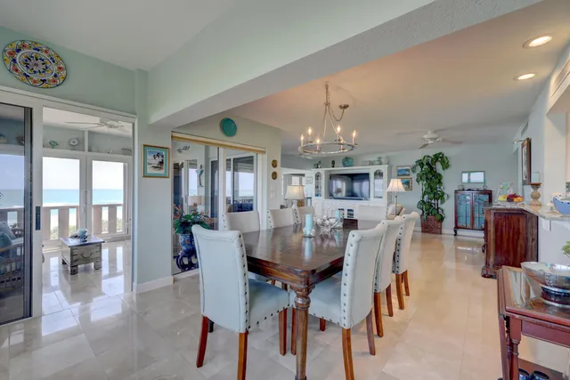a vase of flowers sitting on a table in front of a window