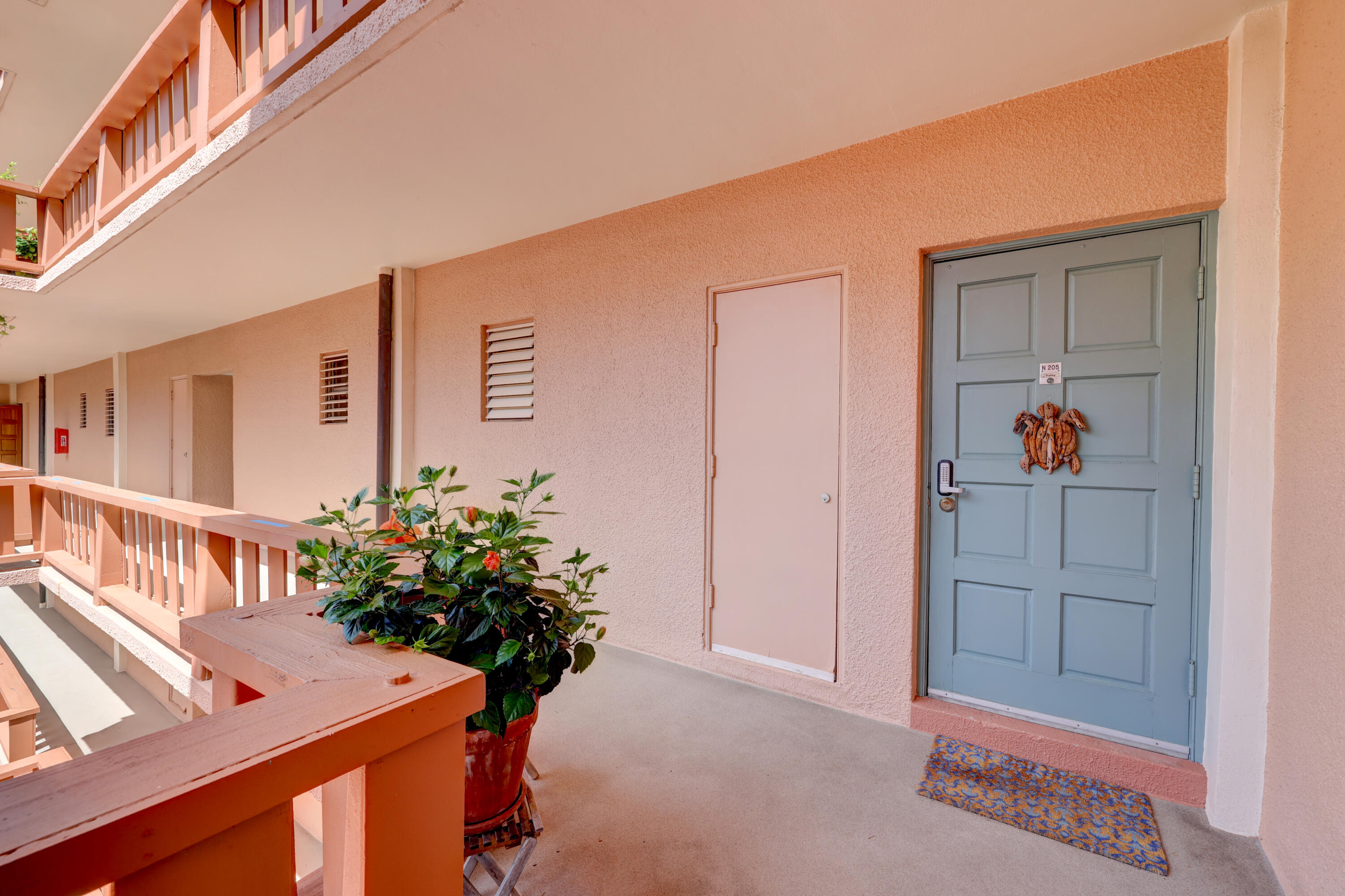 1555 Northeast Ocean Boulevard, Unit 205 Stuart, FL 34996 - Photo 10 of 57 a view of a hallway with a potted plant