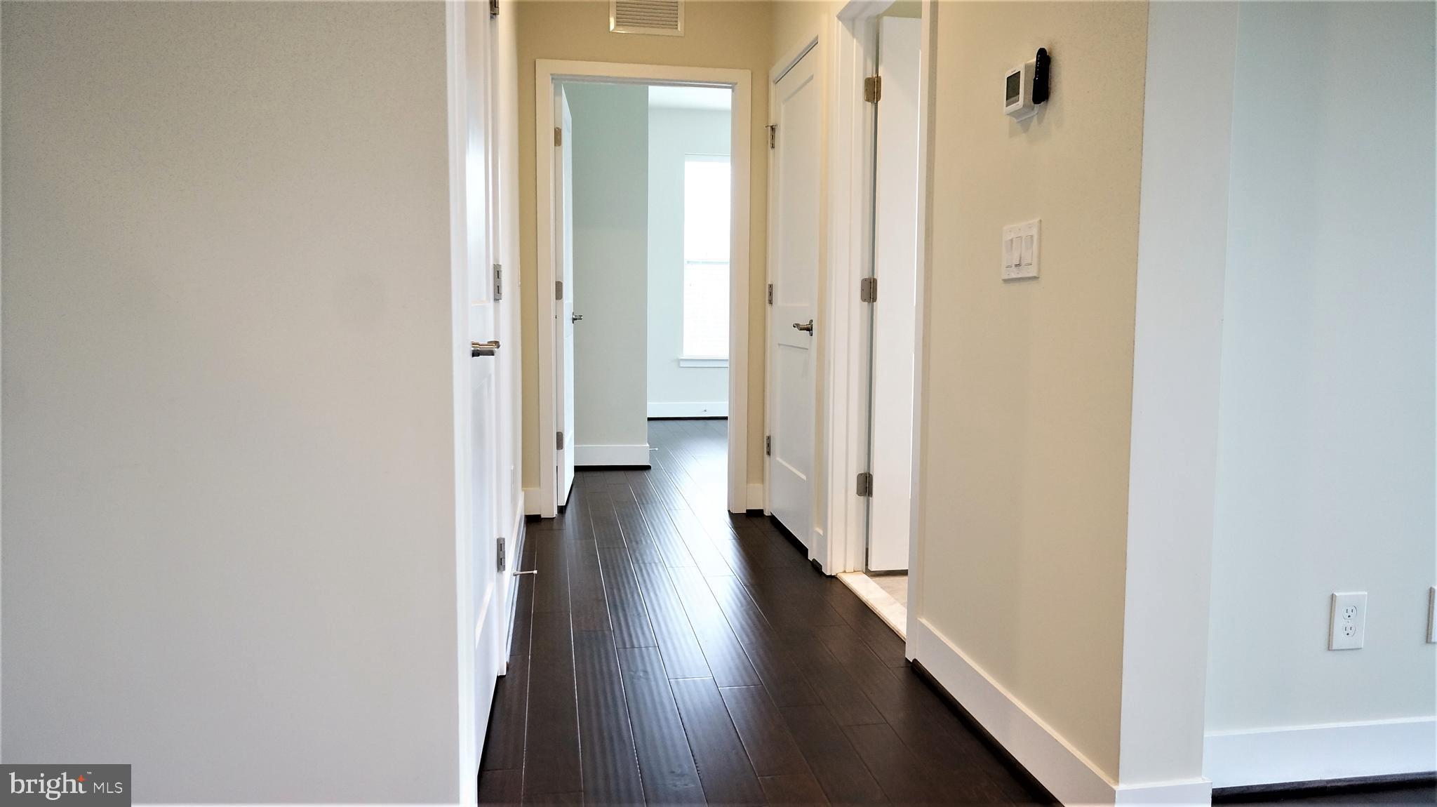 1951 Reston Vly Way, Unit 10 Reston, VA 20191 - Photo 32 of 50 a view of a hallway with a wooden floor