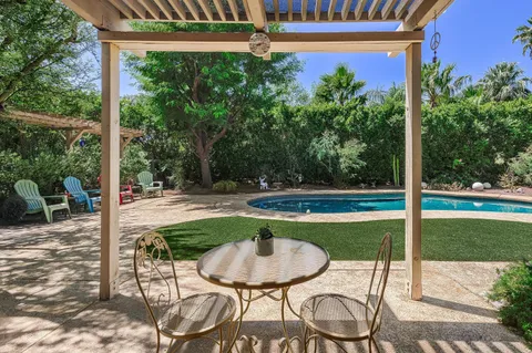 a swimming pool with outdoor seating yard and patio