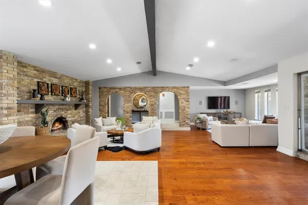 a living room with fireplace furniture and a large window