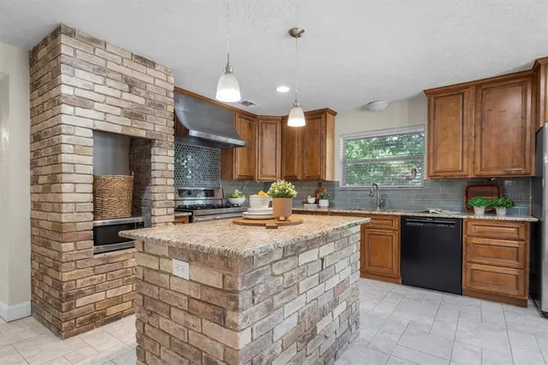 a kitchen with sink cabinets and stove top oven