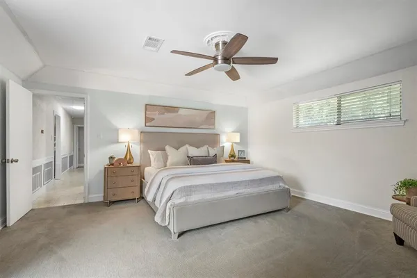 a bed room with a bed and a ceiling fan