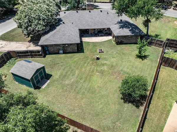 an aerial view of a house with swimming pool and patio