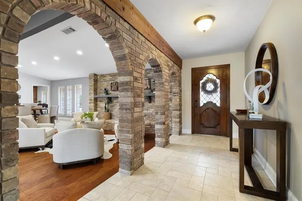 a living room with fireplace furniture and a wooden floor