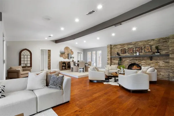 a living room with fireplace furniture and a fireplace