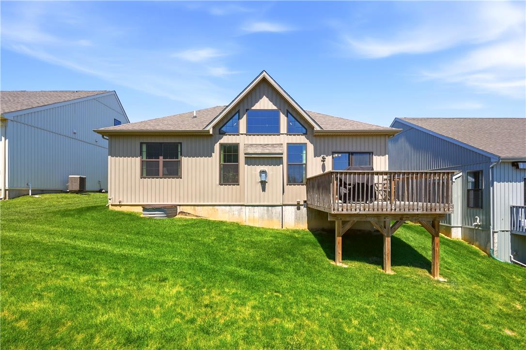 4120 Eveningstar Road Emmaus, PA 18049 - Photo 51 of 62 A striking exterior presents a generously sized deck, perfect for outdoor enjoyment, alongside an expansive verdant lawn.