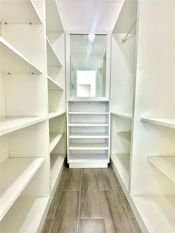a view of closet area with empty racks