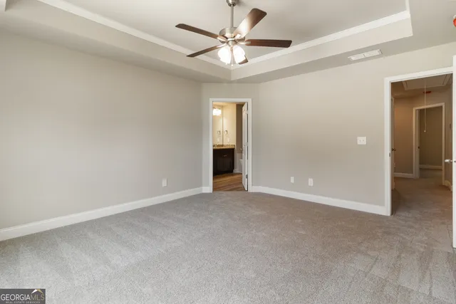 an empty room with a ceiling fan and a window
