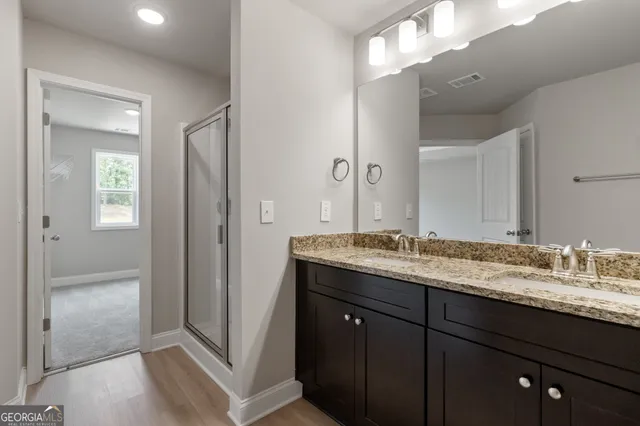 a bathroom with a granite countertop sink and a mirror