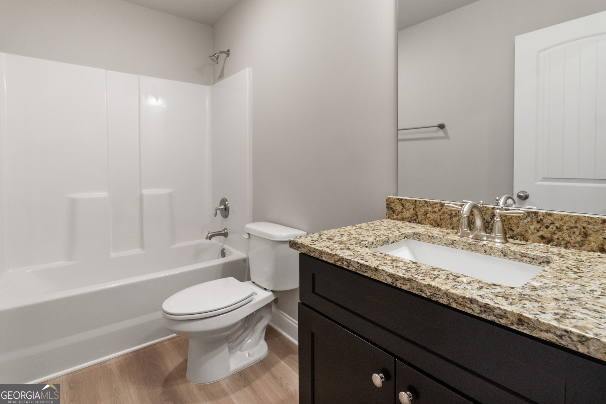 215 Davis Lake Road Thomaston, GA 30286 - Photo 23 of 29 a bathroom with a granite countertop toilet a sink and a bathtub