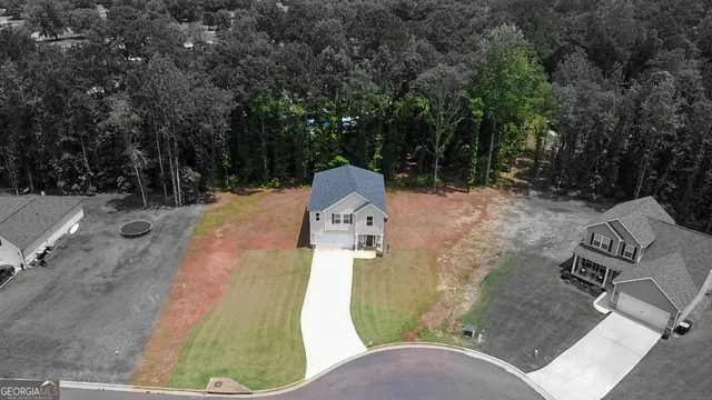 an aerial view of a house with outdoor space