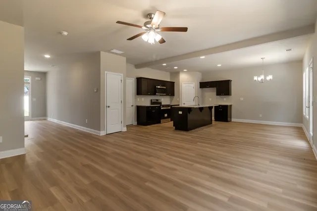 a view of kitchen and a sink with a chandelier fan