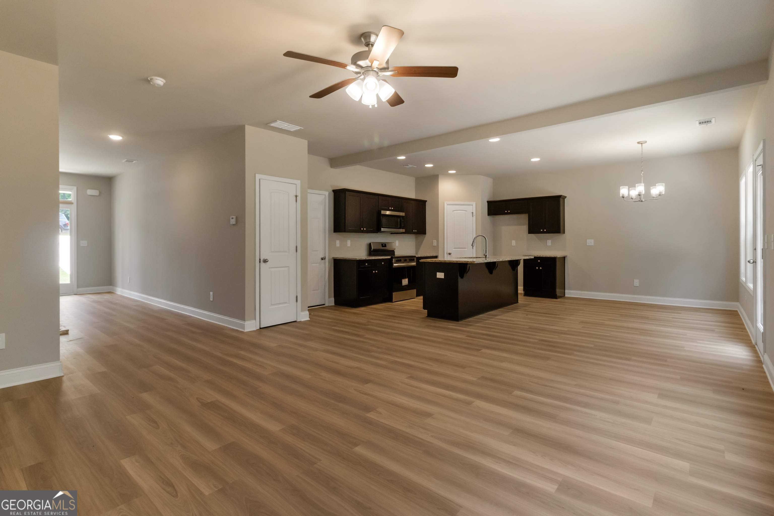 215 Davis Lake Road Thomaston, GA 30286 - Photo 6 of 29 a view of kitchen and a sink with a chandelier fan
