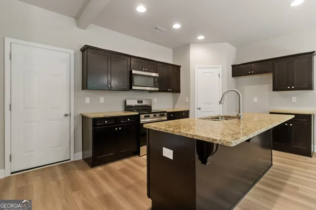 a kitchen with a sink and a microwave