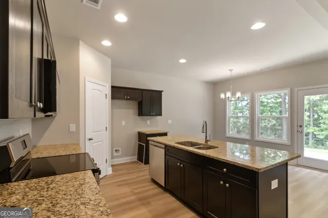 a kitchen with a sink stove and refrigerator