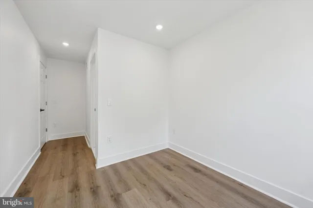 a view of a room with wooden floor and a window