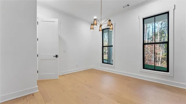 an empty room with windows and entrance