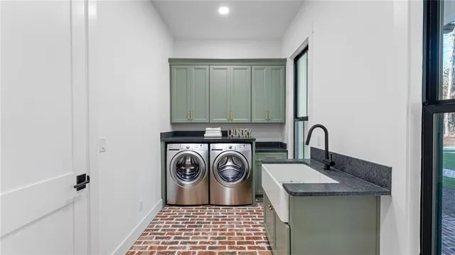 a view of bathroom with sink washer and dryer